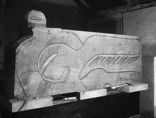 A large block of wood marked up for a sculptor to begin transforming it into a carved artwork