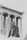Henry Moore, wearing a jacket and tie, standing in front of a columned Greek temple