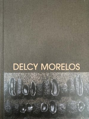 Cover of the book Delcy Morelos, featuring a photo of what looks like casts of fruit or vegetables arranged in two rows.