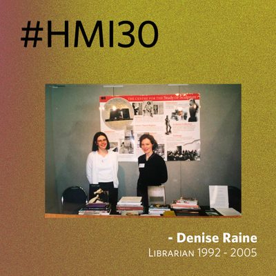 Photo of two young women at a table covered in book, with a poster behind that read 'The Centre for the Study of Sculpture'. - Denise Raine, Librarian 1992-2005