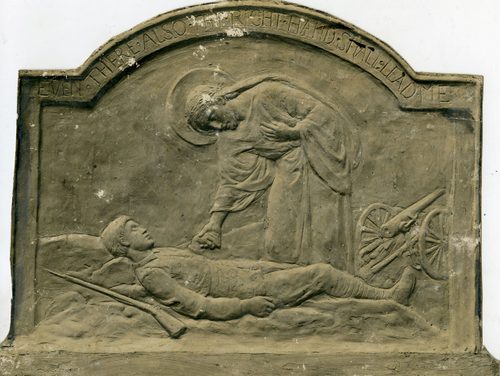 Relief sculpture of Jesus, who is reaching down to hold the hand of a wounded or dead soldier. A rifle has been dropped by the soldier's side, and there is a cannon off to the right. Above the scene words are inscribed, which read: 'Even there also the right hand shall lead me'.