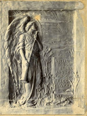 Relief sculpture of an angel holding a long, straight trumpet, looking towards a rising sun in the distance. The words 'Until the day break and the shadows flee away' are inscribed next to them.