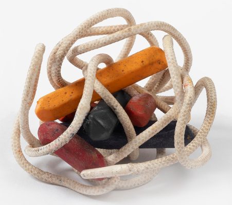 A sculpture of a collection of coloured stones with what appears to be string wrapped around it.