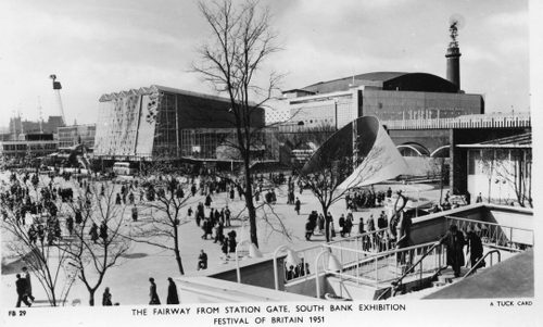 Black and white photo of a large outdoor exhibition space filled with people.