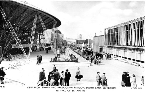 Black and white photo of a large outdoor exhibition space filled with people.