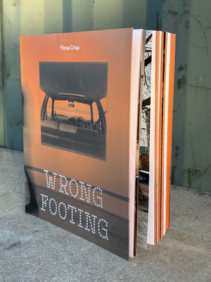 A book with an orange cover, a photograph of the interior of a car and the words 'Fiona Crisp' 'Wrong Footing' on it