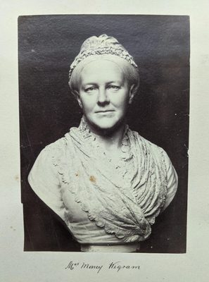 Black and white photo of a portrait bust of a woman.