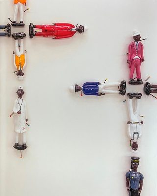 Cover of the book 'Glass Exchange', showing several small figurines pinned to a wall.