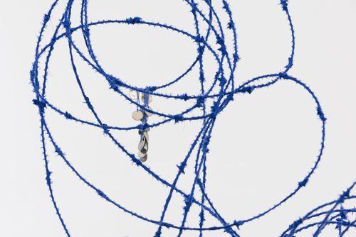 Close up photo of Lungiswa Gqunta’s sculpture 'Ntabamanzi' made from barbed wire and blue wool.