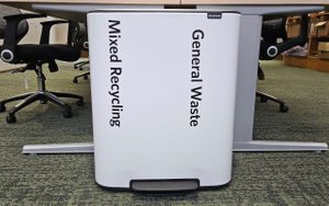 Recycling bin with two containers in an office, labelled 'Mixed Recycling' and 'General Waste'.