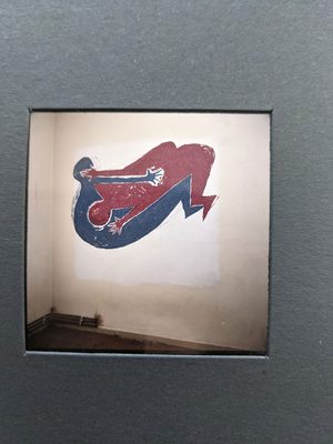 Two simple human figures, one red and one blue, have been painted on a wall. They look to be either fighting or making love; it's deliberately hard to tell which.