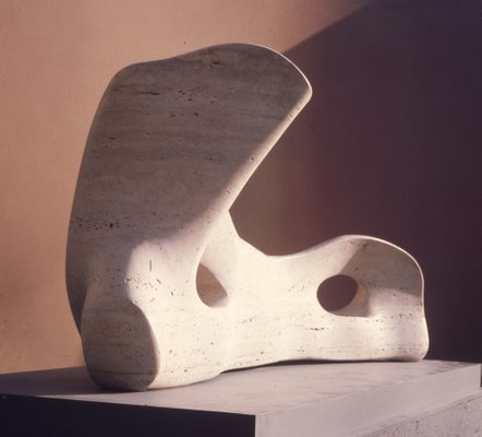A vintage studio photo of a small stone sculpture, which resembles a bone.