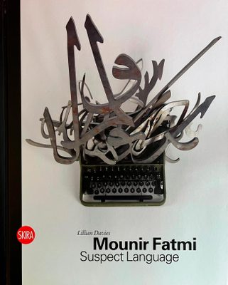 Cover of the book 'Mounir Fatmi: Suspect Language', showing a typewriter with a jumble of large, metal Arabic characters stuffed into the top.