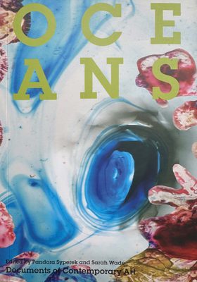 Cover of the book Oceans. The cover features a photo of what looks like blue ink that has been dripped into clear water, with red and yellow shapes collages on top.