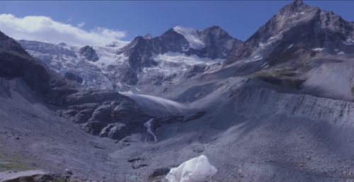Mountain valley where a glacier would once have been, with only a small lump of ice remaining.