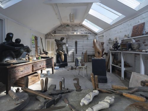 A view into Henry Moore's Top Studio with several work benches, tools and sculptures in progress